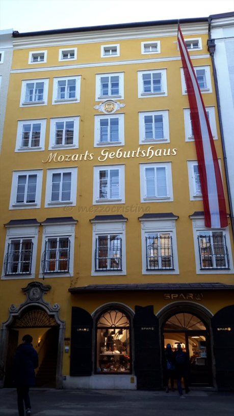 Salzburg 102 - stopping for a few moments in front of Mozart's Birthhouse, at Getreidegasse 9, on a 27 January at noon