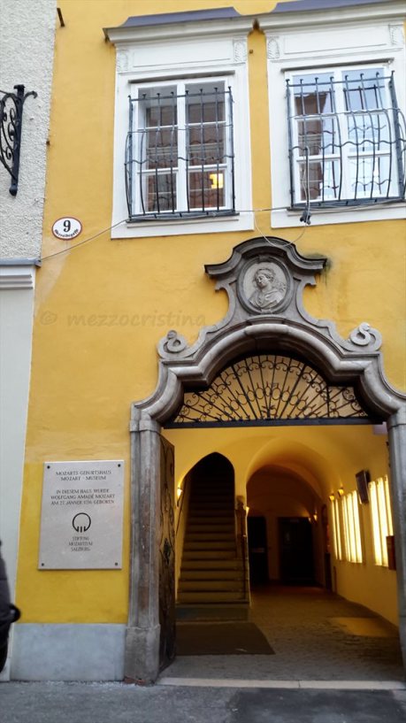 Salzburg 103 - stopping for a few moments in front of Mozart's Birthhouse, at Getreidegasse 9, on a 27 January at noon